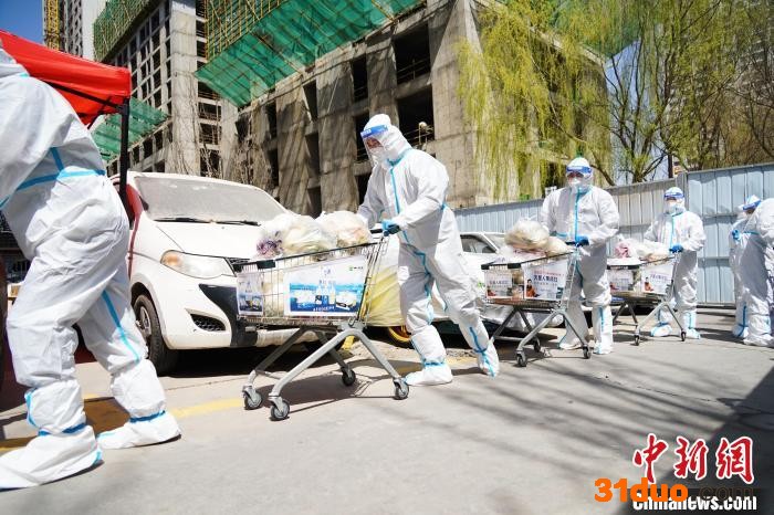 图为防疫人员运送食材。 马铭言 摄