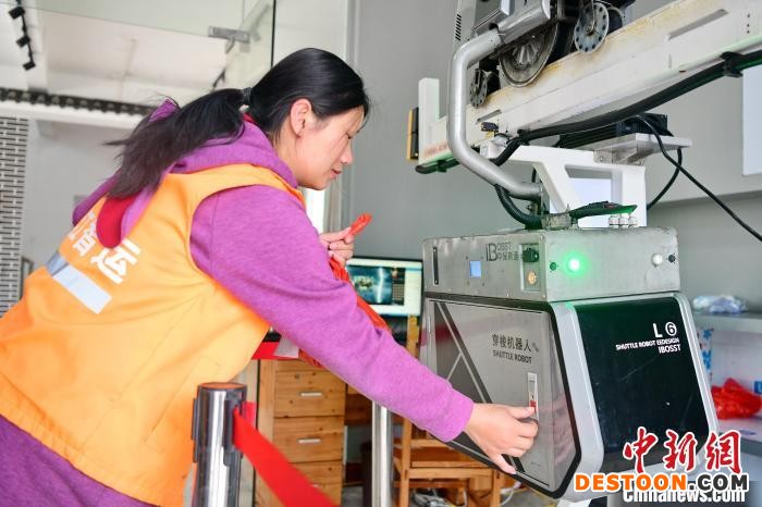 4月14日，江西省赣州市安远县鹤子镇阳佳村，电商服务站的工作人员在操作智慧物流运输快线“穿梭机器人” 朱海鹏 摄