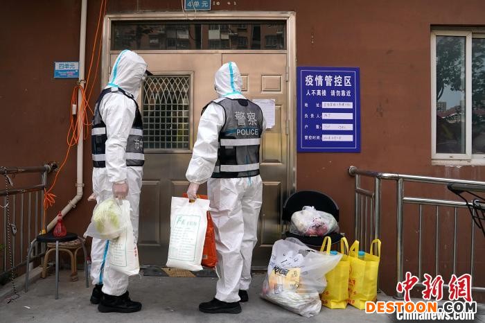 派出所民警给管控区居民送生活物品。 潘永强 摄