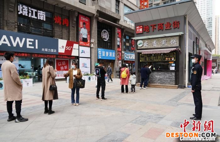 图为市民有序排队购买食品。 马铭言 摄