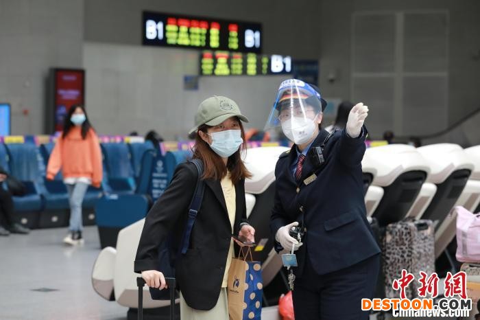 南昌站“红土情”服务台工作人员李军正在回答旅客咨询。 张杰 摄