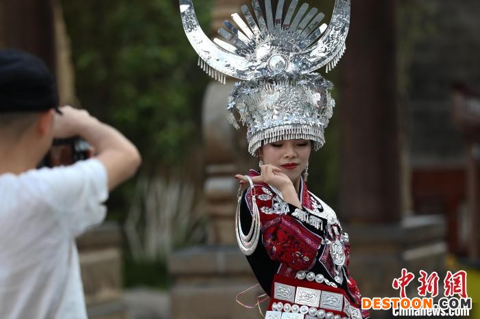 游客穿着少数民族服装在中南门历史文化旅游区拍照。 瞿宏伦 摄